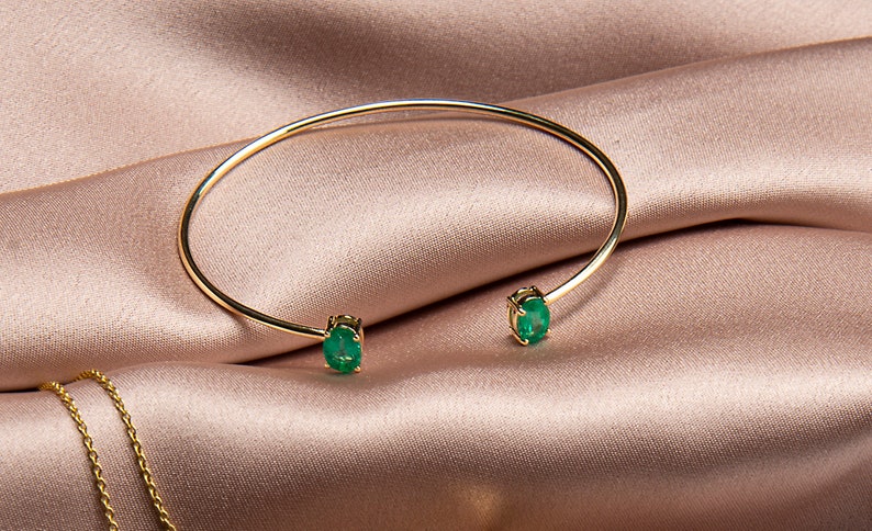 14k yellow gold bangle set with a matching pair oval Cut emerald in India, UK, USA, All Country